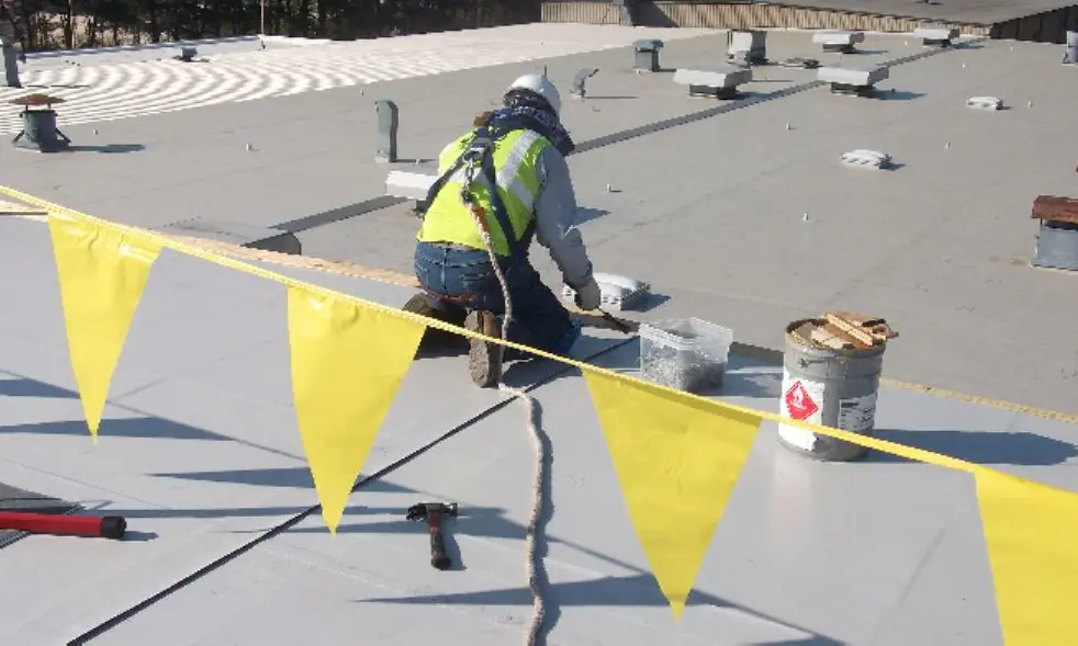 Vanguard Roofer on flat roof in Connecticut performing roof coating solutions. 