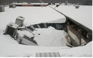 commercial roof that has collapsed under the weight of snow.